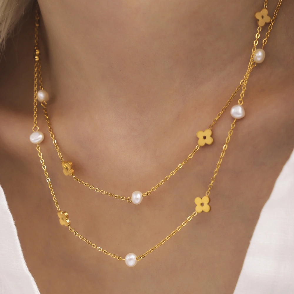 Detail of the matching 18K gold plated stainless steel bracelet featuring pearls and an adjustable extender chain