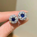 Lab-grown blue diamond halo stud earrings with 5mm royal blue center and black gold cluster setting