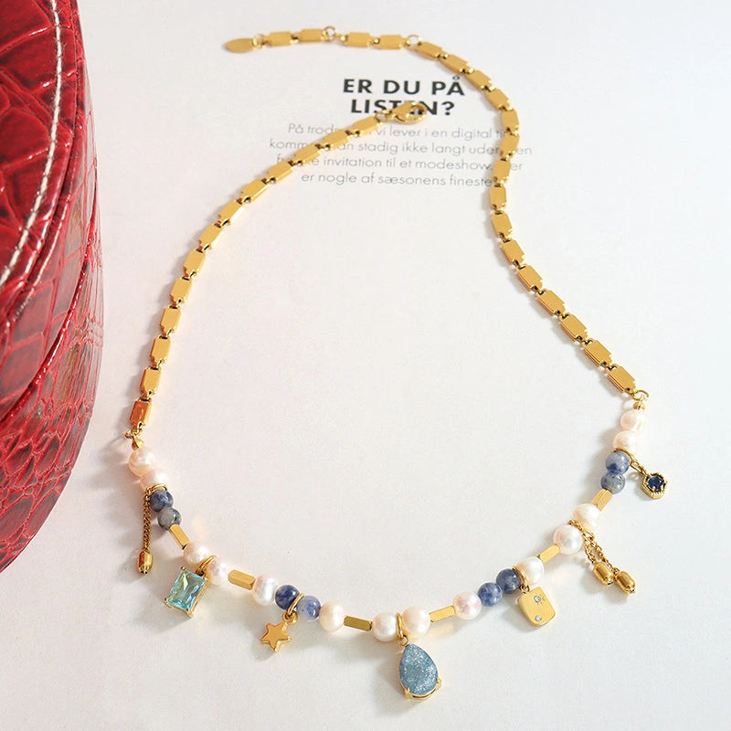 Side view showing the heavy craftsmanship and unique asymmetric arrangement of the mixed-media necklace