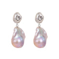 Baroque pearl irregular teardrop earrings with pink iridescent luster, S925 silver studs and star-set crystals. Unique organic drop jewelry for women