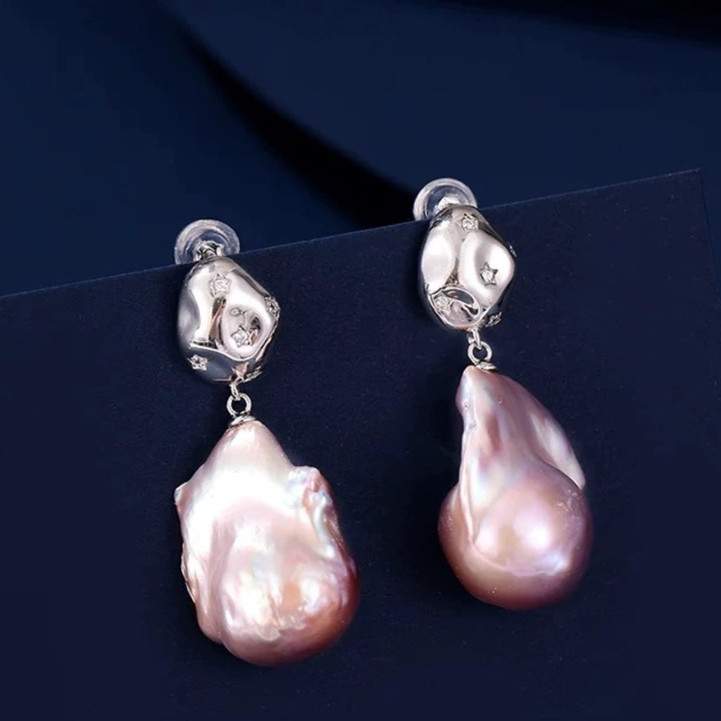 aroque pearl irregular teardrop earrings with pink iridescent luster, S925 silver studs and star-set crystals. Unique organic drop jewelry for women