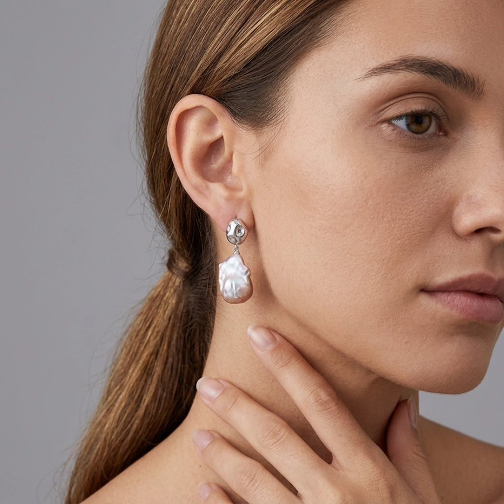 Baroque pearl irregular teardrop earrings with pink iridescent luster, S925 silver studs and star-set crystals. Unique organic drop jewelry for women
