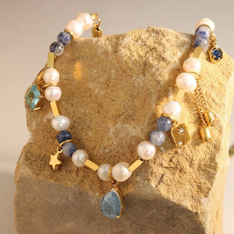 Close-up detail of copper chain spliced with blue natural stones and lustrous freshwater pearls