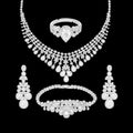 Crystal clear cubic zirconia bridal jewelry set with silver-tone finish. Includes necklace, ring, earrings, and bracelet for weddings and formal wear