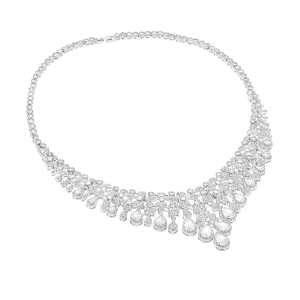 Crystal clear cubic zirconia bridal jewelry set with silver-tone finish. Includes necklace, ring, earrings, and bracelet for weddings and formal wear