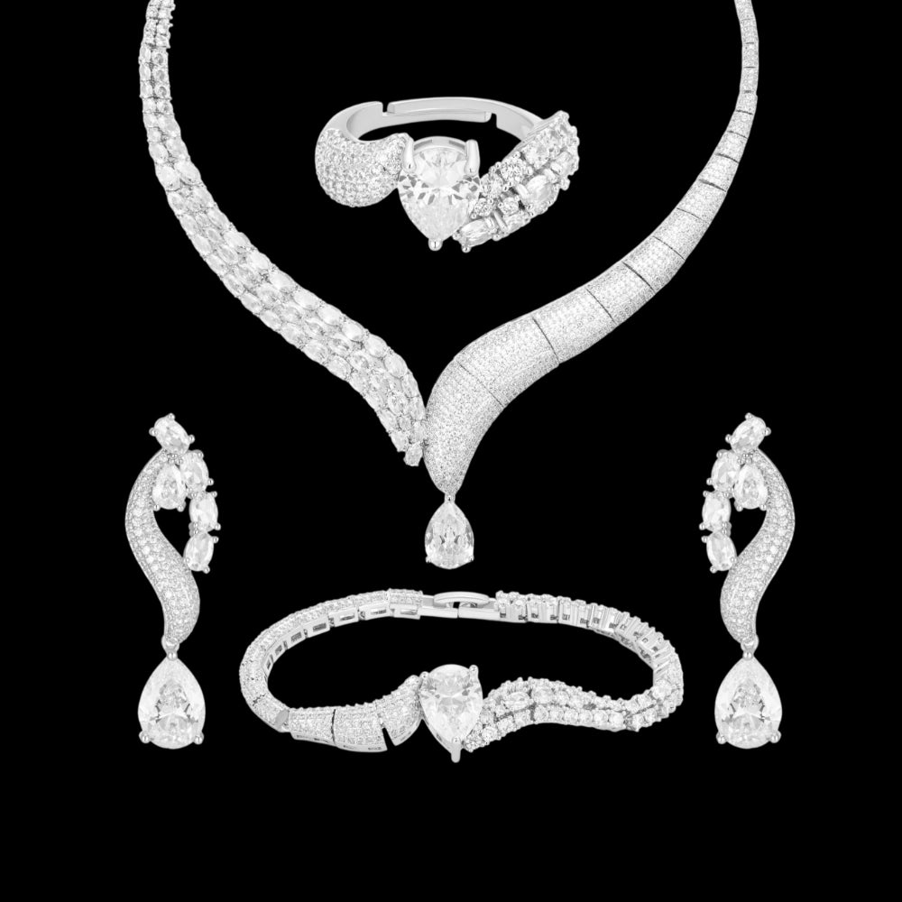 Crystal clear cubic zirconia jewelry set with silver-tone finish. Includes necklace, ring, earrings, and bracelet for weddings and formal wear