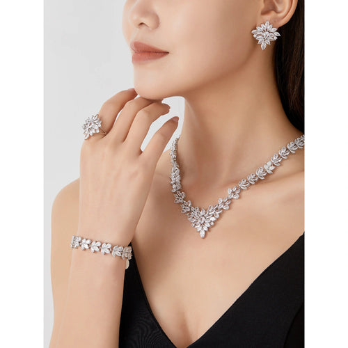 Crystal clear zircon jewelry set with silver-tone finish. Includes necklace, ring, earrings, and bracelet for weddings and formal wear