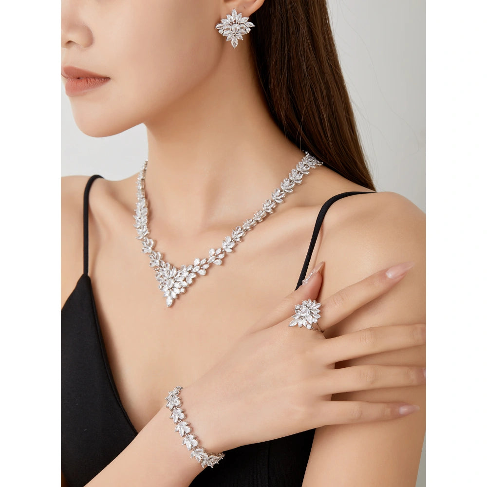 Crystal clear zircon jewelry set with silver-tone finish. Includes necklace, ring, earrings, and bracelet for weddings and formal wear