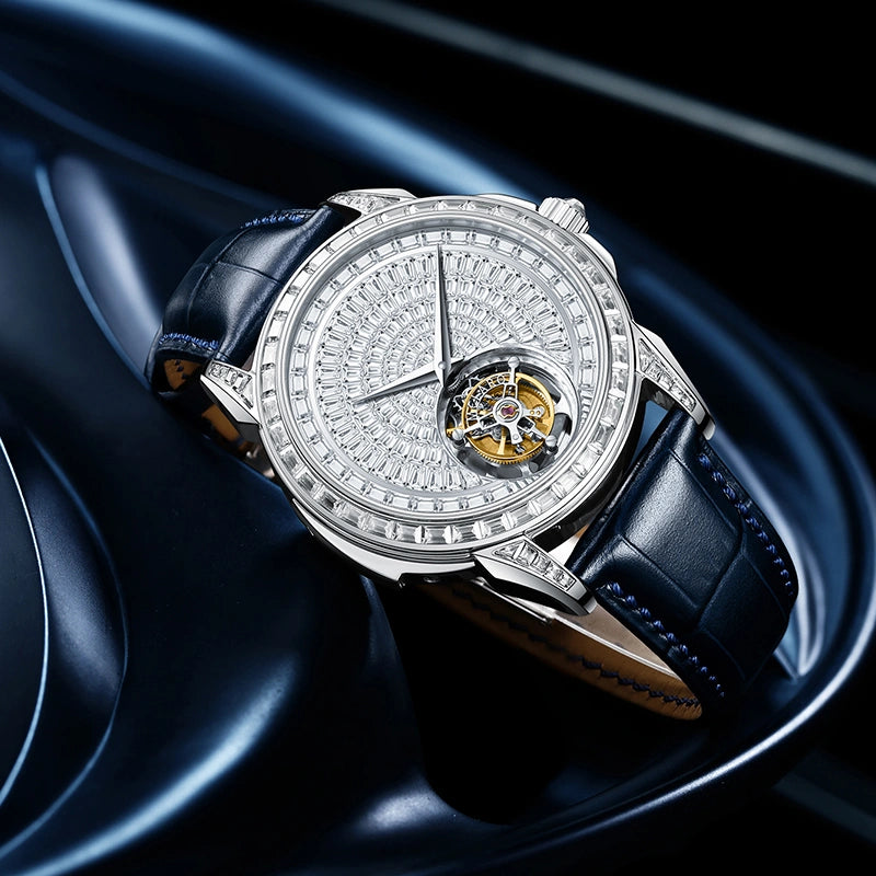 Side angle view of luxury crystal paved tourbillon watch showing sparkling bezel and blue strap