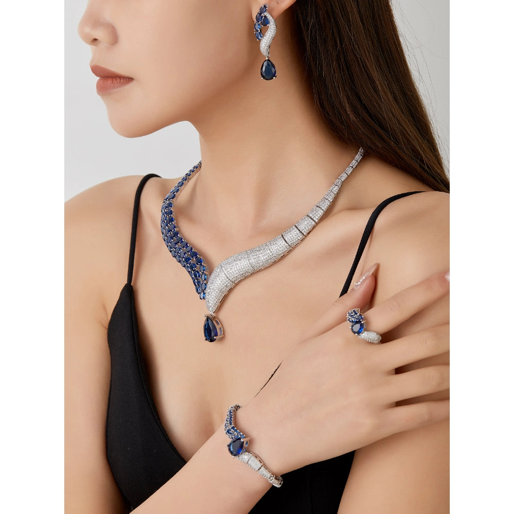 Emerald green and sapphire blue zircon jewelry set with silver-plated copper. Includes necklace, ring, earrings, and bracelet for weddings and formal wear