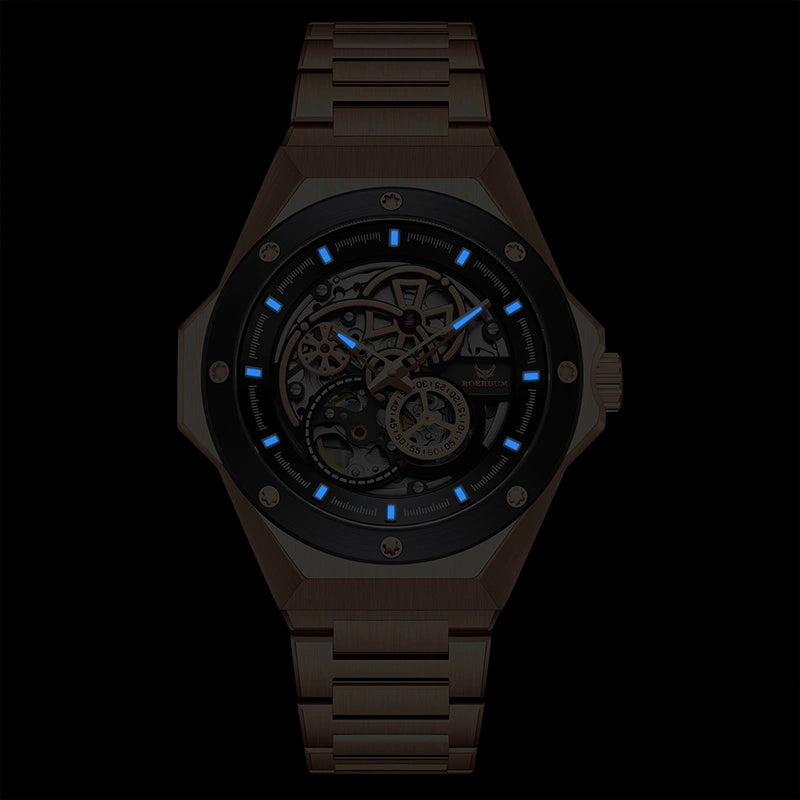 Blue luminous hands and hour markers glowing in the dark on rose gold skeleton watch