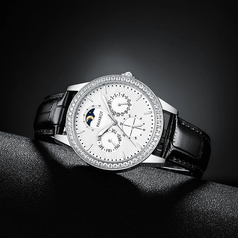 Luxury white dial mechanical watch displayed on textured black background   