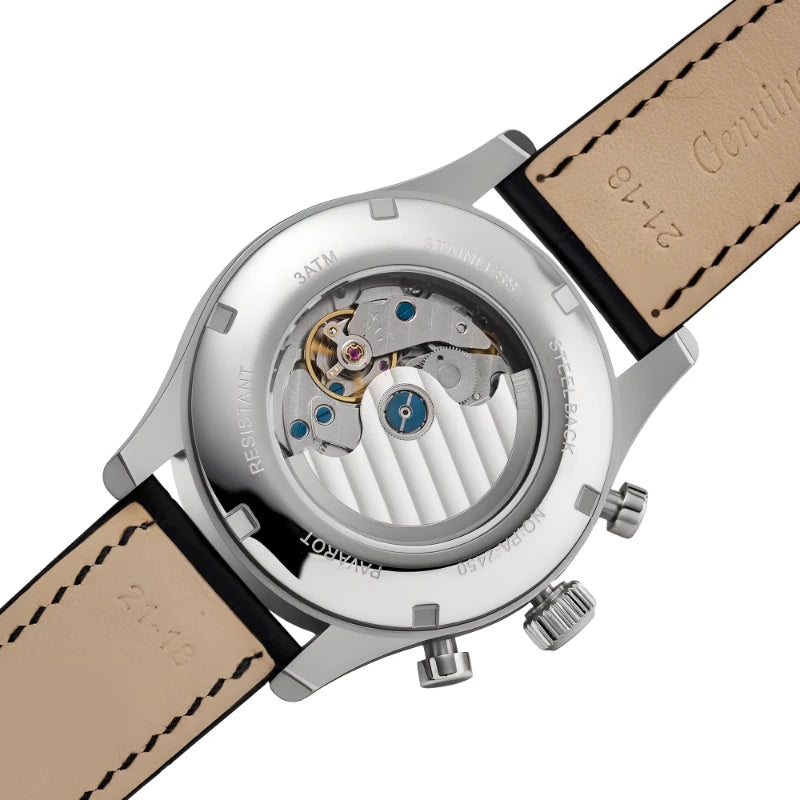 Front view of men's black chronograph watch dial with tachymeter scale, moon phase, and date window