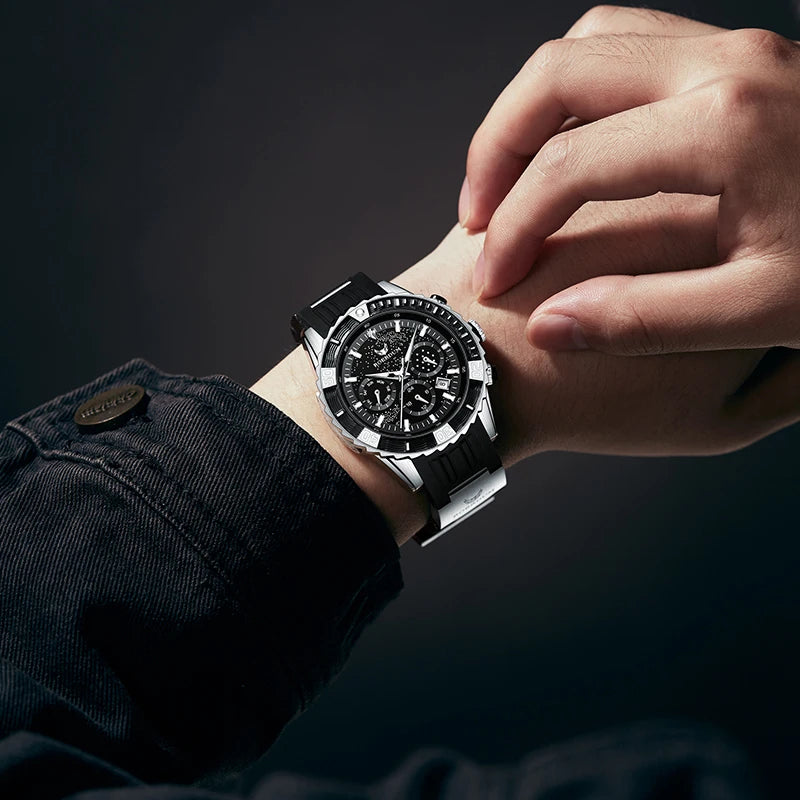Close-up wrist shot of man wearing black starry dial watch with black jacket sleeve