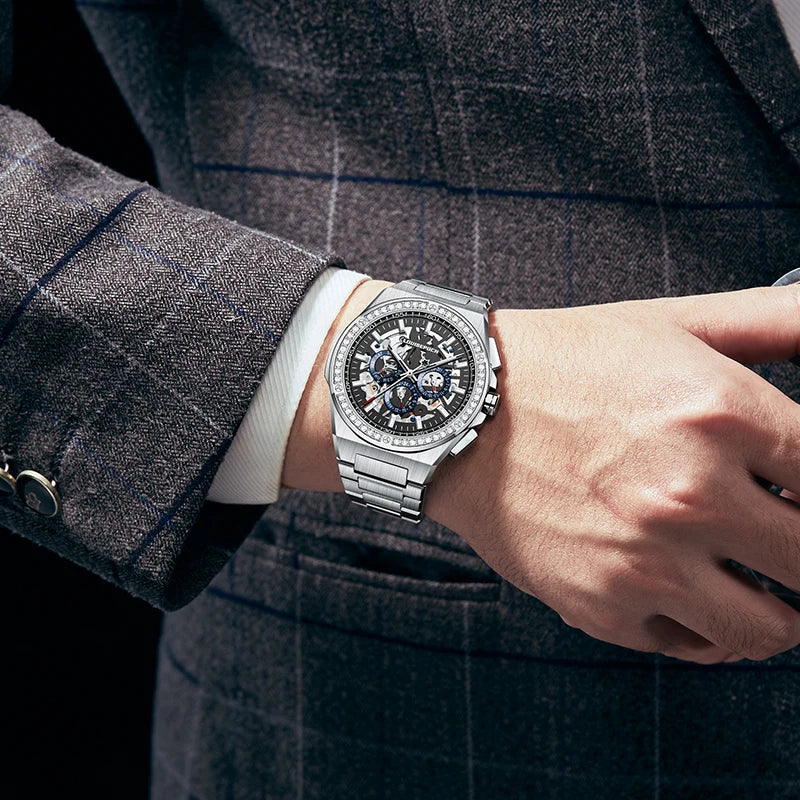Professional wrist shot of a stainless steel automatic mechanical watch with a plaid suit jacket