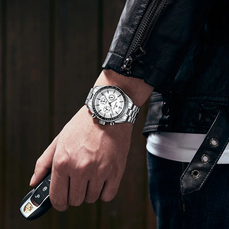Lifestyle shot of a man wearing a steel watch while holding a car key