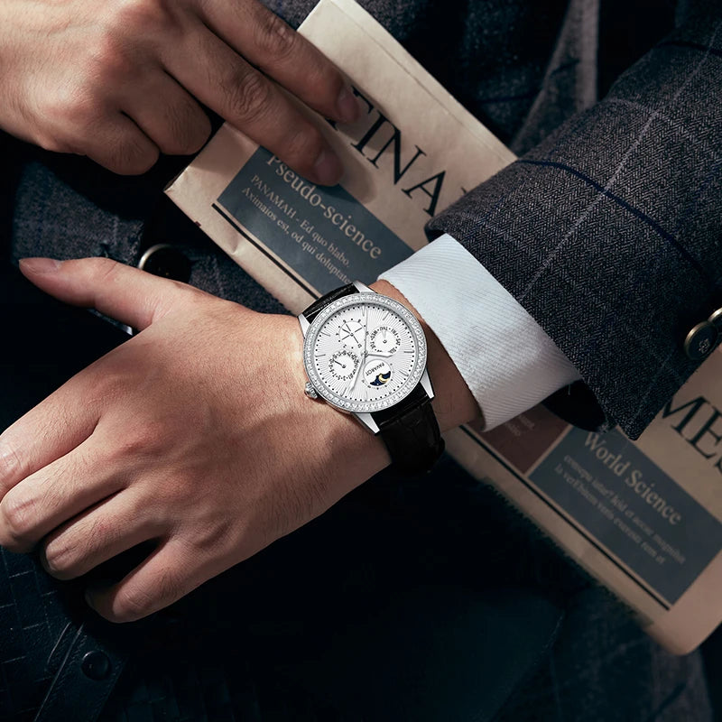 Close-up of man wearing white dial multi-function watch on wrist holding newspaper