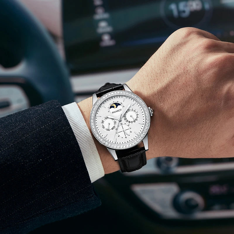 Man wearing diamond bezel automatic watch on wrist while driving in suit jacket