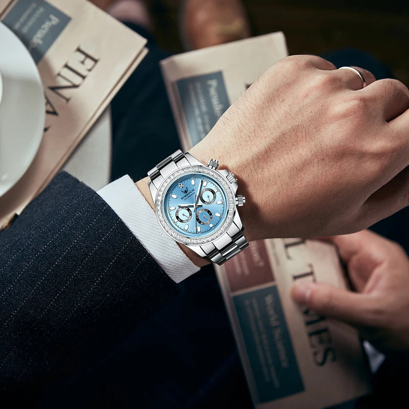 Close-up wrist shot of man wearing ice blue automatic watch with pinstripe business suit