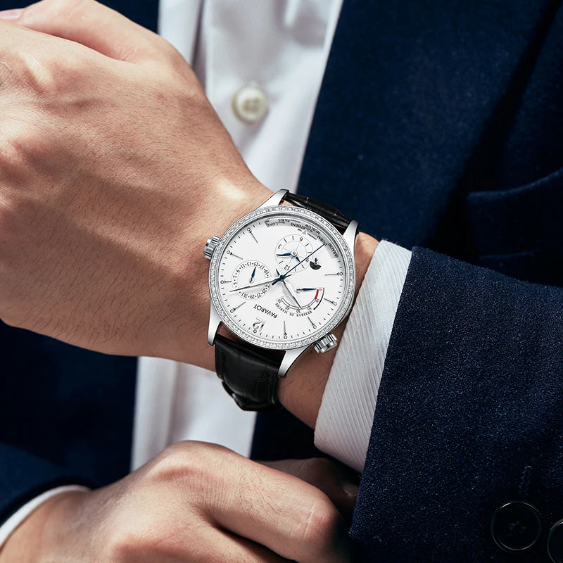 Man wearing white dial multi-function automatic watch with navy blue suit jacket