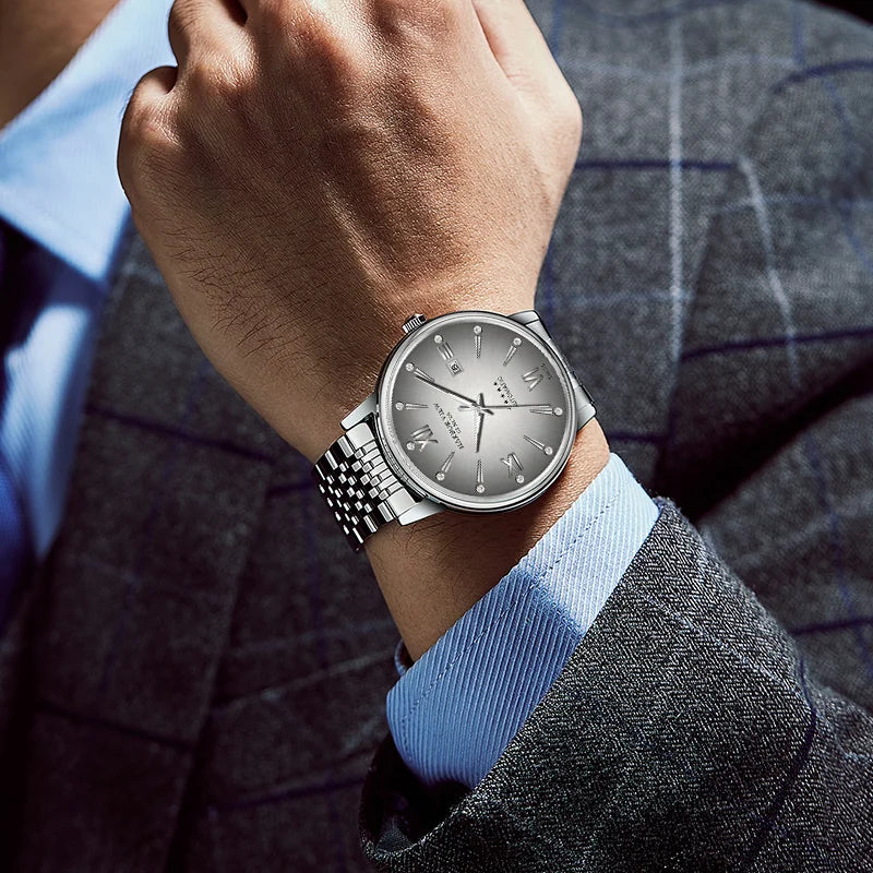 Wrist shot of a stainless steel automatic dress watch worn in a formal business setting