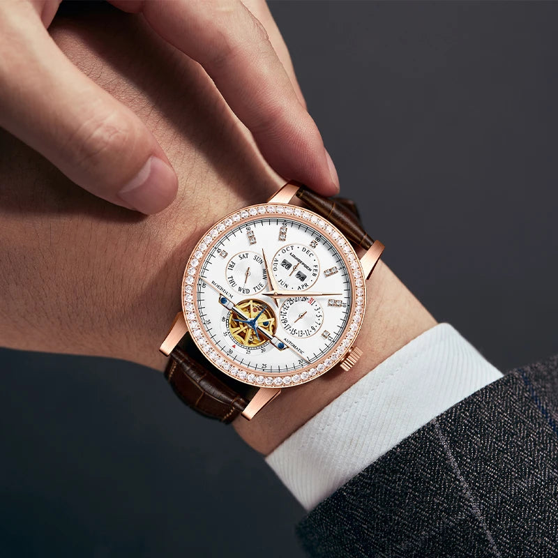 Close-up wrist shot of man wearing 44mm rose gold diamond automatic watch with business attire