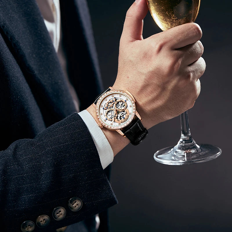 Man wearing rose gold skeleton watch with black suit jacket while reading newspaper