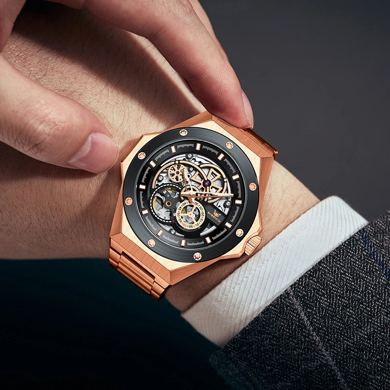 Man wearing rose gold skeleton mechanical watch on wrist with dress suit cuff