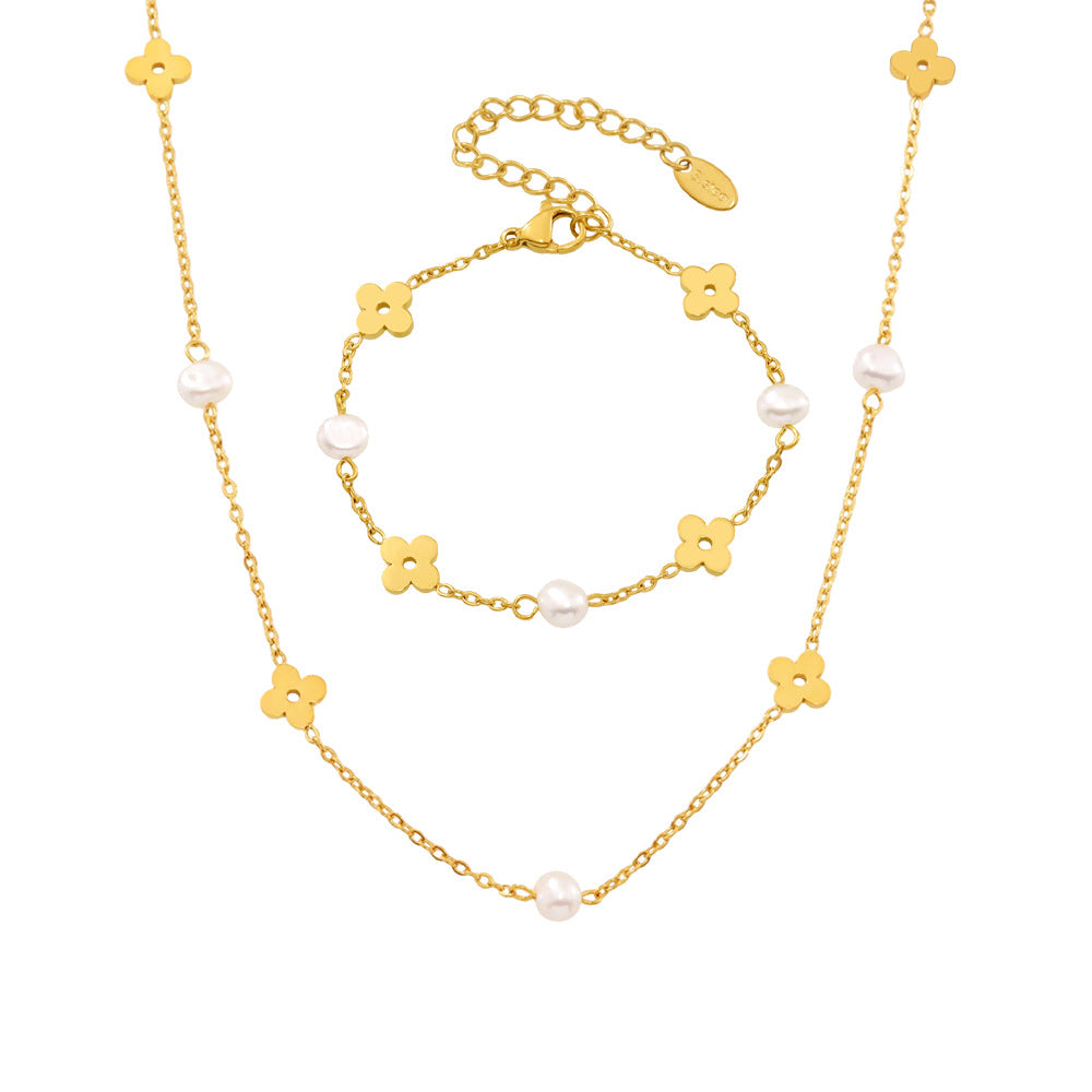 Model wearing a dainty 18K gold plated flower necklace and freshwater pearl bracelet set