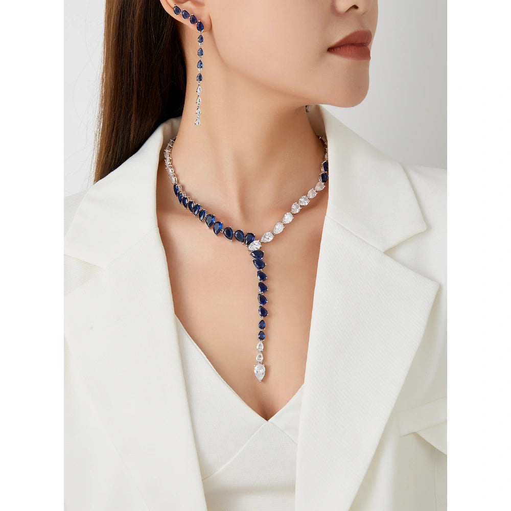 Sapphire blue and emerald green cubic zirconia jewelry set with silver-tone finish. Includes Y-necklace and dangle earrings for weddings and formal wear