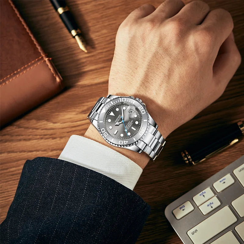 Men's luxury stainless steel automatic watch worn on wrist next to a keyboard and notebook
